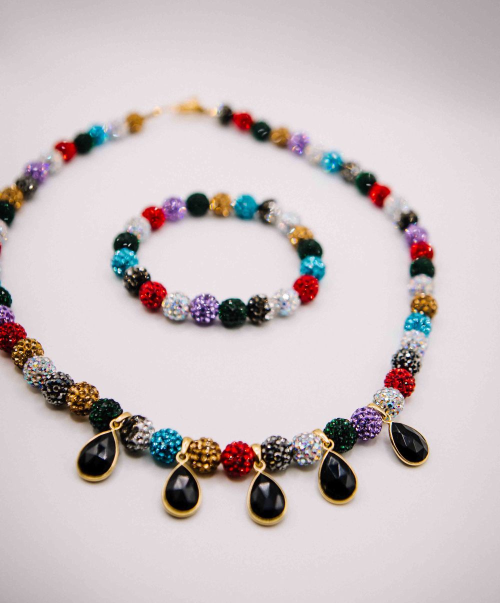 Colorful beaded necklace with teardrop-shaped beads on a light background