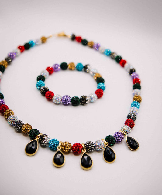 Colorful beaded necklace with teardrop-shaped beads on a light background
