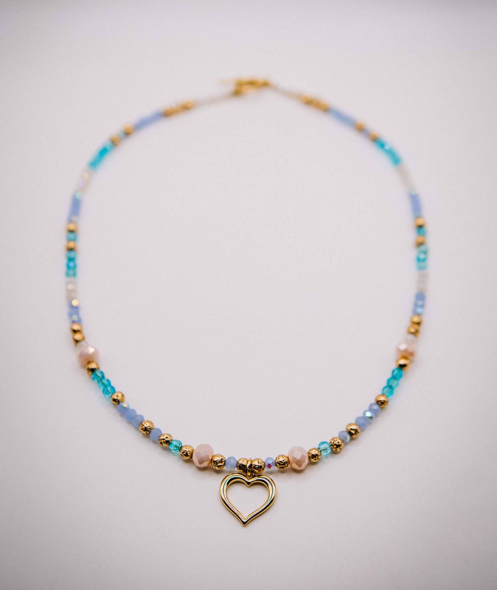 Necklace with heart charm and multicolored beads on a light gray background