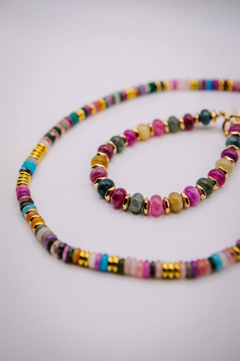 Colorful beaded necklace on a light gray background